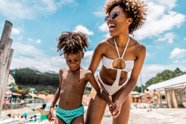 istock Mother talking with son at water park 1944666925