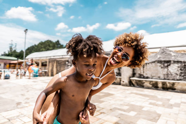 istock Mother talking with son at water park 1944667433