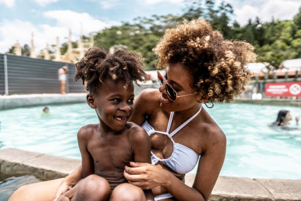 istock Mother talking with son at water park 1944667446