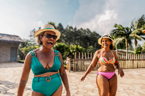 istock Mother and daughter talking at water park 1944674251