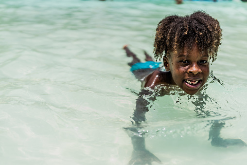 Portrait of a child swimming at water park pool