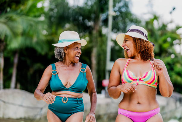 istock Mother and daughter talking at water park 1944677013