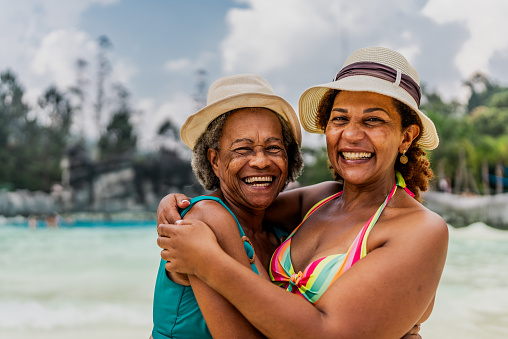 Portrait of mother and daughter embracing at water park