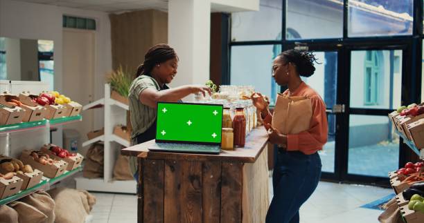 istock Vendor presenting eco goods on shelves next to greenscreen 1944680191