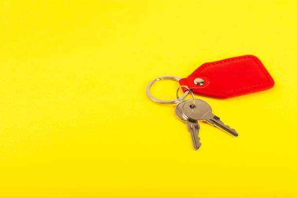 istock Keychain with key ring isolated on a colored background. Concepts for real estate and moving home or renting property. Buying a property. Mock-up keychain.Copy space. 1944681818