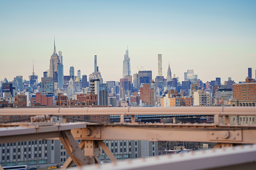 Panorama view of New York city from Brooklyn bridge at sunset.