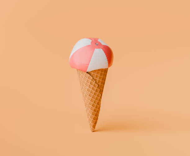 istock Beach Ball on Ice Cream Cone Against Peach Background 1944699899