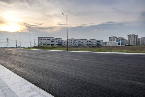 Empty asphalt road and cityscape in summer