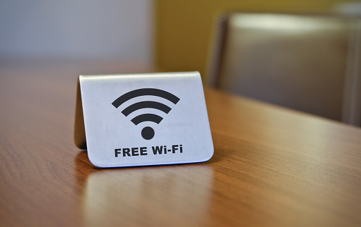 Free Wifi sign - with blurred business background (hotel, restaurant, office, public building)