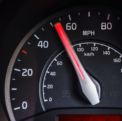 A speedometer needle moving past 50mph on a car journey.