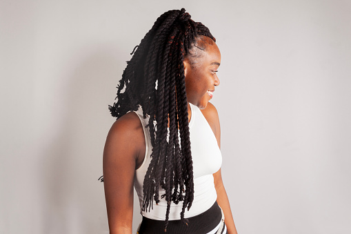 backside dreadlocks head closeup, fashionable girl posing at old wooden door background