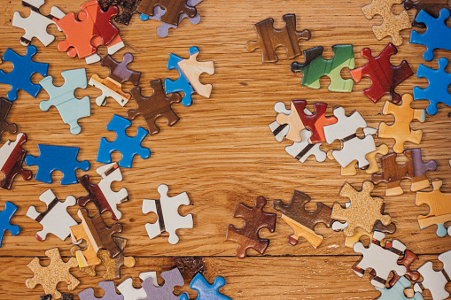 Above angle view of a large group of puzzle pieces on a table