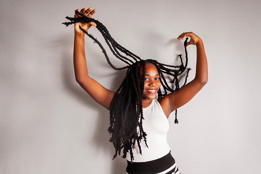 Portrait of beautiful women touching twist braid hair