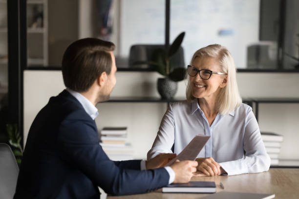 istock Two happy business partners speaking at meeting table 1944774932