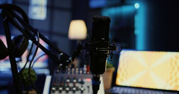 istock Zoom in on professional mic in dimly lit studio used for recording audio during internet show 1944799021