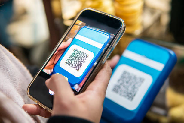 Magnifier over fake QR code on yellow background. Horizontal composition.