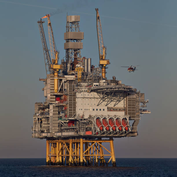 istock Helicopter landing on jack up oil rig in the ocean. 1944802417