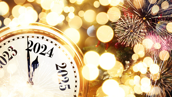 Gold retro clock shows New Year 2024 with golden lights, Christmas tree and vintage toys. Happy New Year and Christmas card