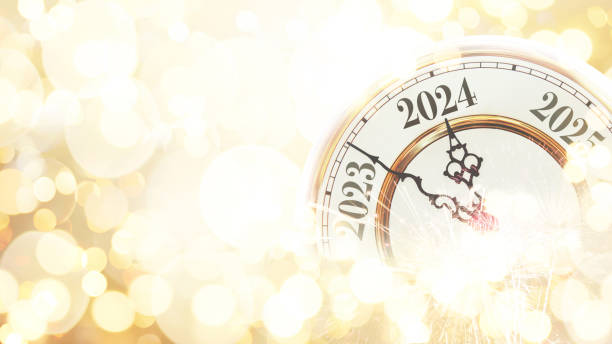 istock Vintage gold clock points to 2024 New Year on a beige bokeh background with fireworks, concept. New Year and Christmas card, creative idea. Celebration and party 1944804577