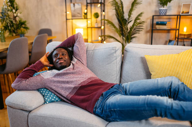 istock Young Man Relaxing On The Sofa At Home At Night 1944807184