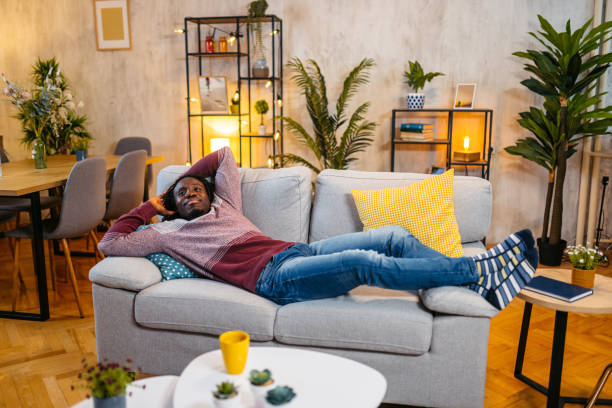 istock Young Man Relaxing On The Sofa At Home At Night 1944818259