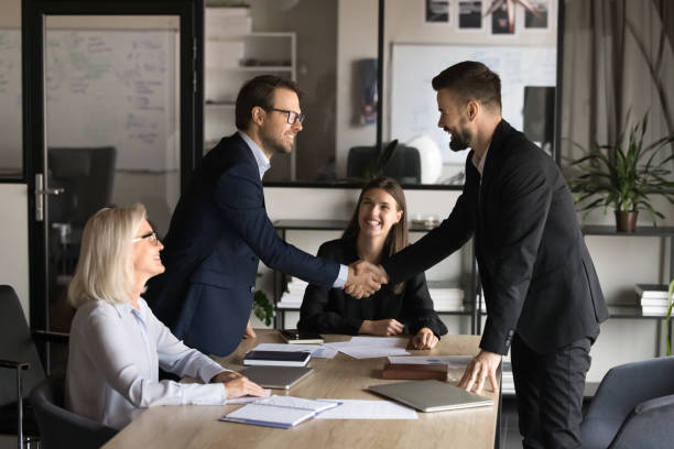 istock Two happy confident business partners men shaking hands 1944818261