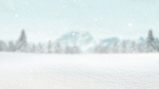 Beautiful winter with snow in a field with forest and mountains bokeh background. Winter card and free space for design