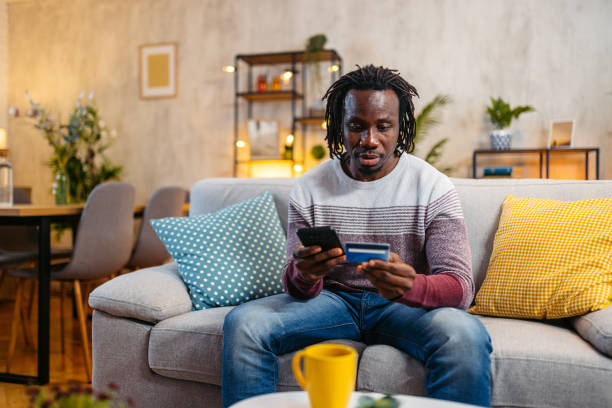 istock Young Man Shopping Online Using Smart Phone At Home At Night 1944819808