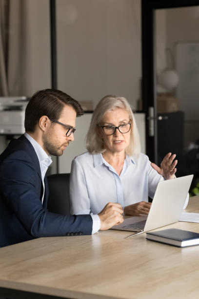 Confident business colleagues couple analyzing online project content