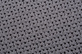 Structure of light gray fabric with holes in macro close-up