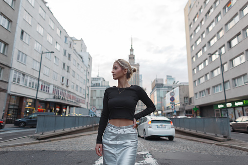 Urban fashionable beautiful woman in fashion clothes walking on the street in the city