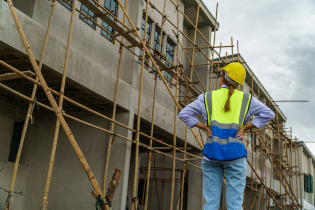 istock women civil engineers Wearing a safety helmet, reflective suit, standing inside a construction site. 1944851389