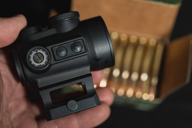 istock Red dot sight for a rifle in a man's hand, close-up photo. 1944862120