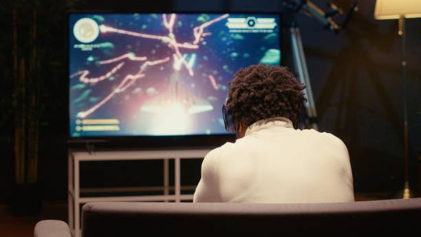 istock Gamer receiving game over screen on television set, getting his spaceship destroyed 1944888701