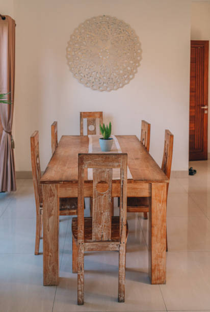 istock Wooden table with chairs at window with nature view 1944889231