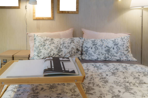 Cozy bedroom adorned with a soft lamp, casting a warm and inviting glow. This scene embodies a serene retreat, perfect for winding down and embracing the comfort of a well-lit, intimate space