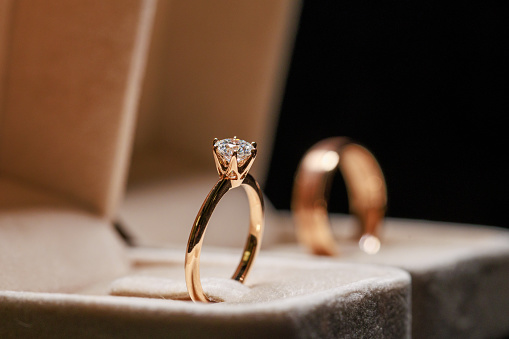 Close-up of the wedding rings of the bride and groom in a box