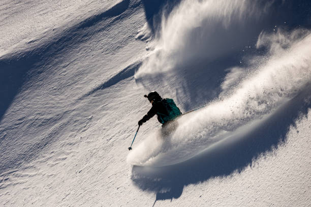 istock Freeride skier making a turn in fresh powder snow 1944926337