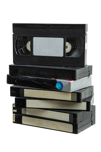Pile of VHS video cassettes. Vintage media. Isolate on a white background.