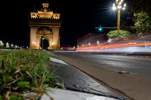 Beautiful architecture Patuxay monument (Victory Gate) and Light trails from car lights at night in Vientiane, Laos.