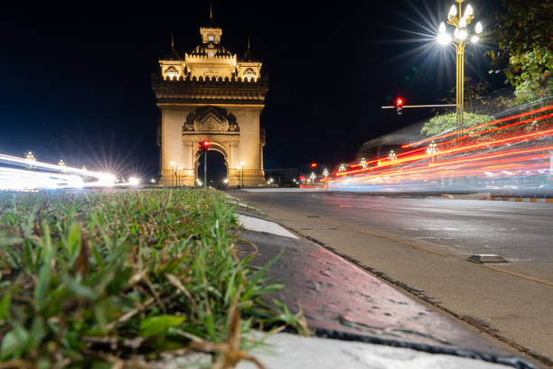 Beautiful architecture Patuxay monument (Victory Gate) and Light trails from car lights at night in Vientiane, Laos.