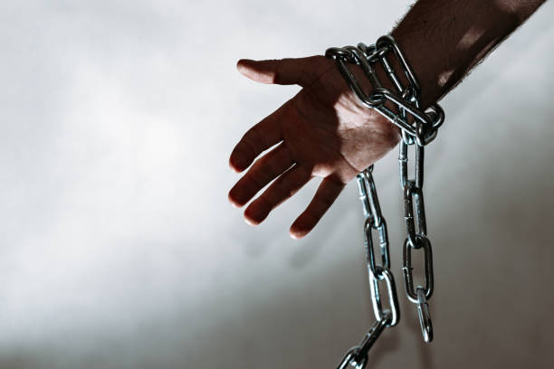 istock Hand with chain hang,chain in hand,the chain wound on the hand,gray background.Copy space. 1944971481