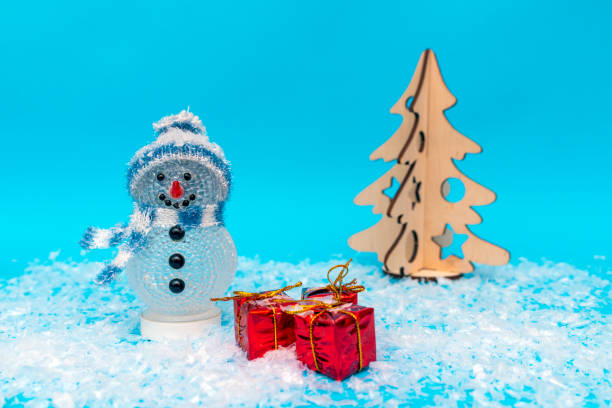 istock snowman, presents and Christmas tree.new year celebration. 1944972556