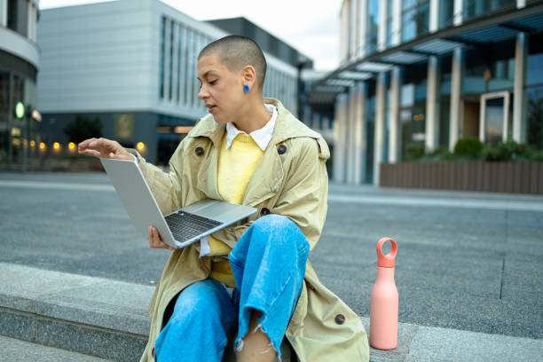 istock Business Woman Using Laptop Outdoors 1944974632