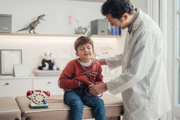 istock Doctor examining young boy 1944983459