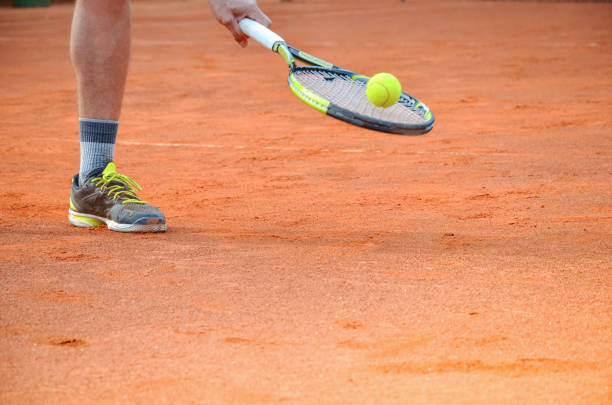 Man preparing to serve tennis ball first