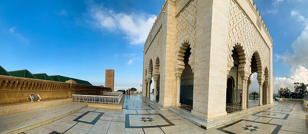 Panoramic view Guard soldier in national costumeThe Mausoleum of Mohammed V is a historical building located on the opposite side of the Hassan Tower  on the Yacoub al-Mansour