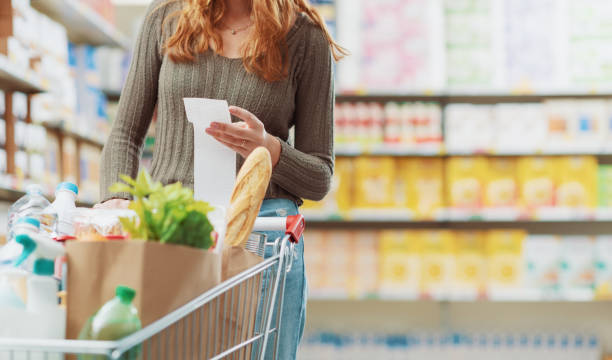 istock Customer checking the grocery receipt at the supermarket 1945017052