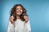 A woman holding an invisible aligners for dental correction.