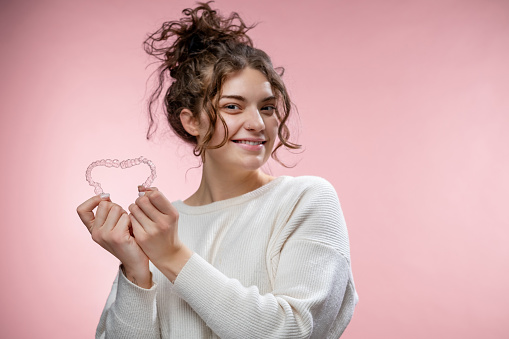 Invisible braces or aligners for a beautiful smile.